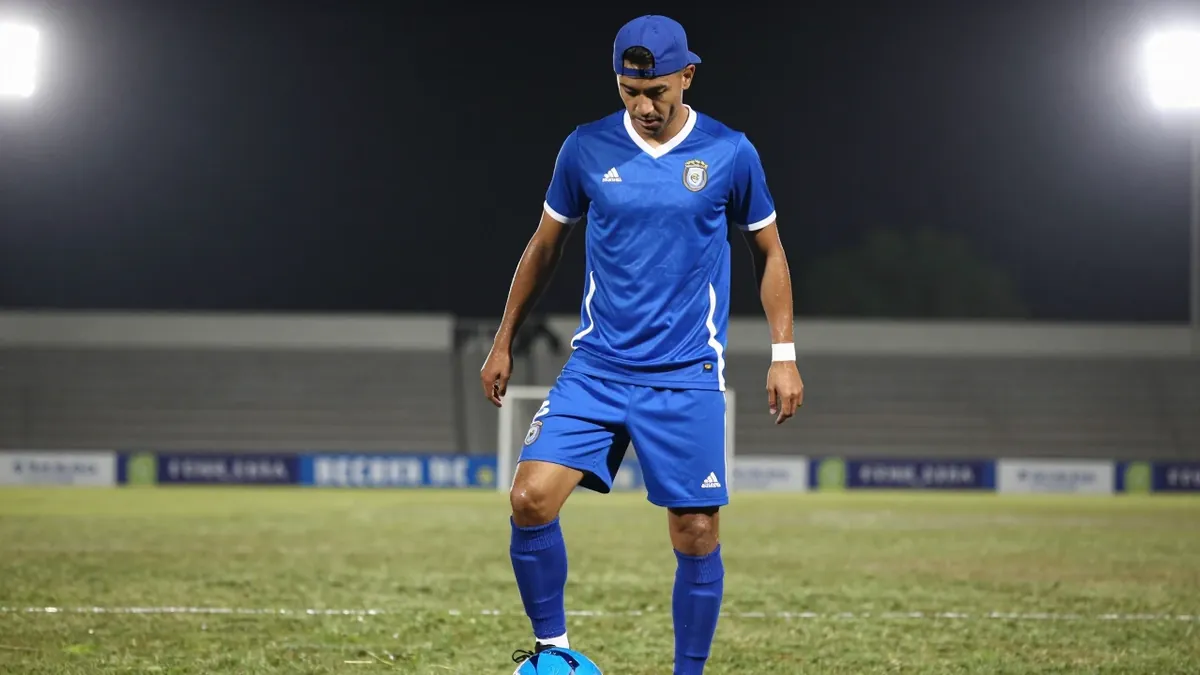 A photorealistic image of a 30-year-old Necaxa player in a blue jersey with a white stripe, wearing a blue cap and blue...
