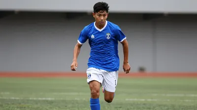 A tight action crop of an anonymous young Necaxa Under 21 player in a bright blue jersey with white shorts, running with...